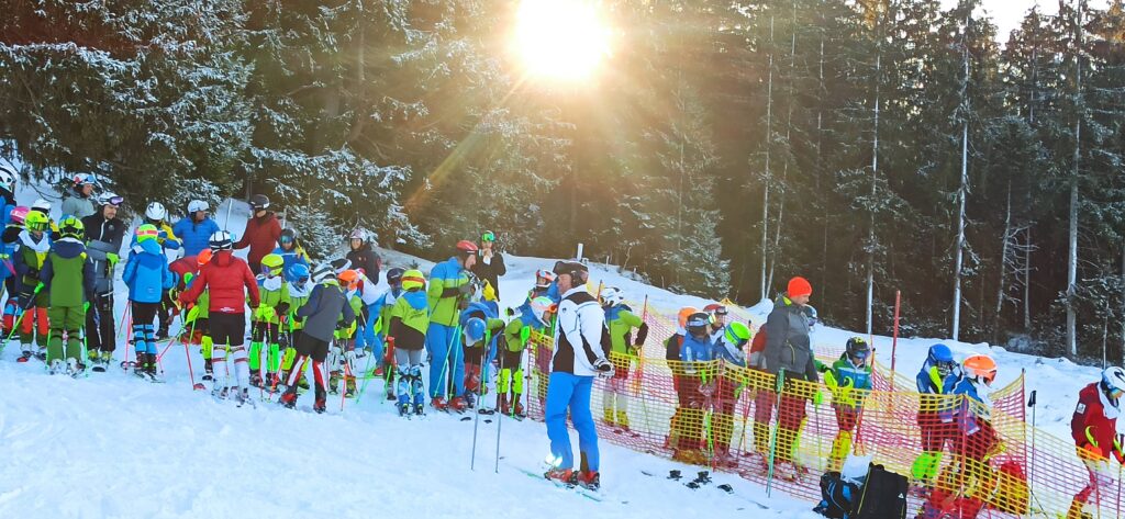 mom watching alpine ski racers during a race inspection  in the Austrian Alps